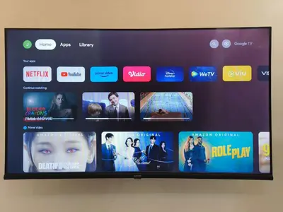 a television screen with a bunch of movies on it at Justin Guest House in Jimbaran