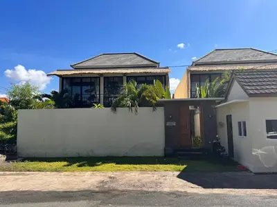 a house with a white fence in front of it at Villa de Mer Bali in Legian
