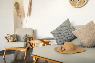 a living room with a couch with a hat on it at LaLeBay Villa Seminyak in Seminyak