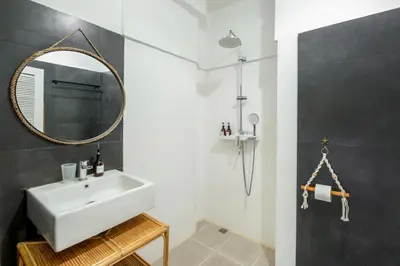 a bathroom with a white sink and a mirror at LaLeBay Villa Seminyak in Seminyak