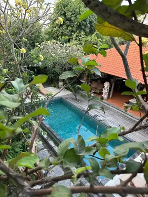 a swimming pool in the middle of a garden at Bali Telaga Hati Yoga Healing And Retreat Center Hostel in Sanur