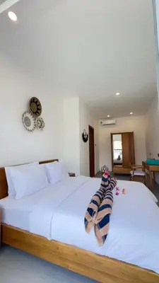 a bedroom with a large white bed with towels on it at 2 bedroom villa in Umalas in Kerobokan
