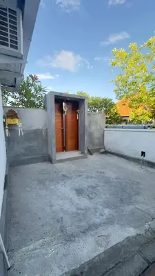 a house with a orange door in a yard at 2 bedroom villa in Umalas in Kerobokan