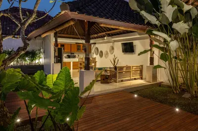 a house with a wooden deck at night at 2 Bedroom Villa private Pool and BBQ Seminyak Bali in Seminyak