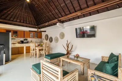 a living room with a table and chairs and a kitchen at 2 Bedroom Villa private Pool and BBQ Seminyak Bali in Seminyak