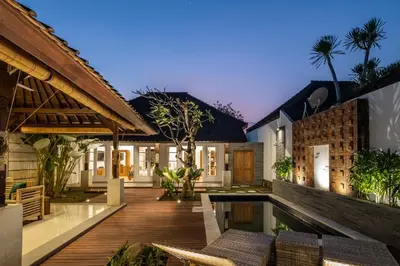 an outdoor patio with chairs and a table at 2 Bedroom Villa private Pool and BBQ Seminyak Bali in Seminyak