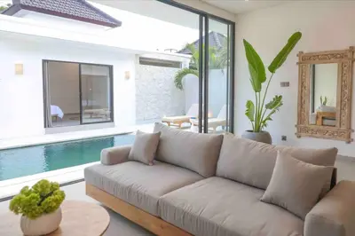 a living room with a couch and a swimming pool at Villa Efire-3 bedroom with pool in Seminyak
