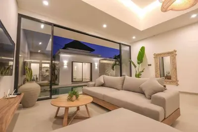 a living room with a couch and a table at Villa Efire-3 bedroom with pool in Seminyak