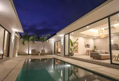 a house with a swimming pool at night at Villa Isea-3 bedroom with pool in Seminyak