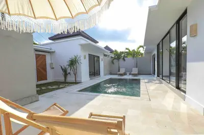 a villa with a swimming pool and a house at Villa Isea-3 bedroom with pool in Seminyak
