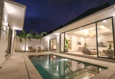 a villa with a swimming pool at night at Villa Isea-3 bedroom with pool in Seminyak