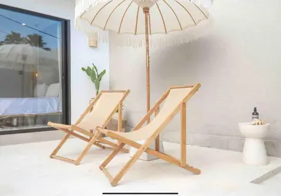 a chair with an umbrella in a room at Villa Isea-3 bedroom with pool in Seminyak