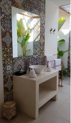 a bathroom with a sink and a mirror at Milavila in Seminyak