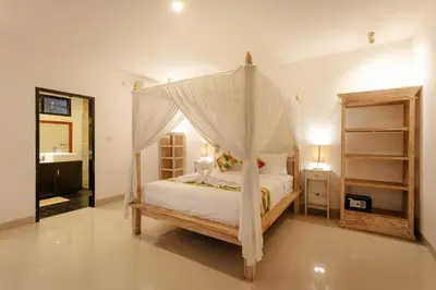 a bedroom with a bed with a canopy at Villa Sri, Seminyak - 3 Bedroom Stylish Pool Villa! in Seminyak