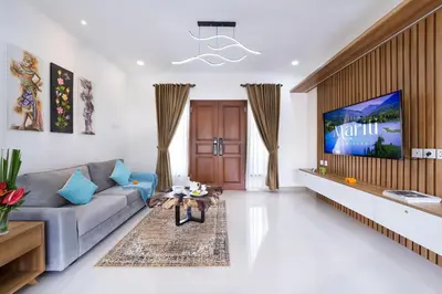 a living room with a couch and a tv at Villa Marili Seminyak by Nagisa Bali in Seminyak