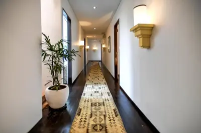 a hallway with a potted plant on the floor at Melo Suites Hotel in Seminyak