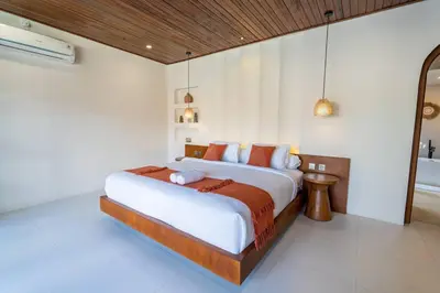 a bedroom with a large bed in a room at Green Jimbaran Bay Villa II in Jimbaran