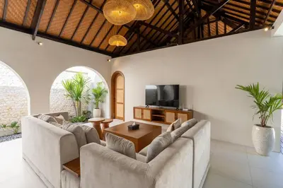 a living room with two couches and a television at Green Jimbaran Bay Villa II in Jimbaran