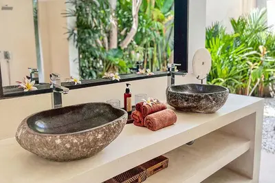 a bathroom with two vessel sinks on a counter at Villa Kallayaan by Optimum Bali Villas in Seminyak