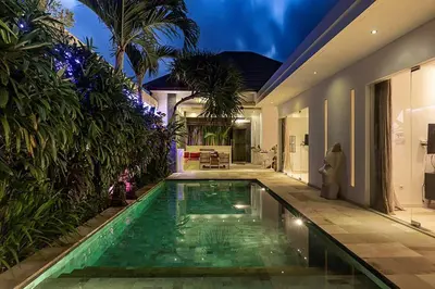 a swimming pool in the middle of a house at Villa Kallayaan by Optimum Bali Villas in Seminyak