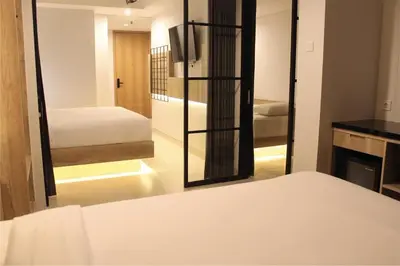 a bedroom with a mirror and a bed in a room at Anagata 1 Tanjung Benoa Bali in Nusa Dua