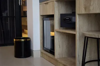 a kitchen with a microwave and a trash can at Anagata 1 Tanjung Benoa Bali in Nusa Dua