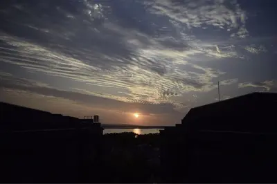 a sunset over a body of water with the sun at Anagata 1 Tanjung Benoa Bali in Nusa Dua