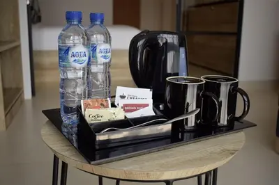 a table with two bottles of water and two cups at Anagata 1 Tanjung Benoa Bali in Nusa Dua