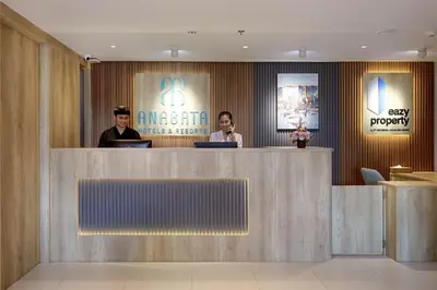 two people sitting at a counter in a lobby at Anagata 1 Tanjung Benoa Bali in Nusa Dua