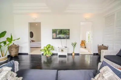 a living room with a couch and some plants at W villa in Seminyak