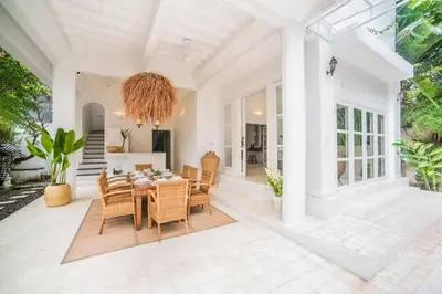 a dining room with a table and chairs at W villa in Seminyak