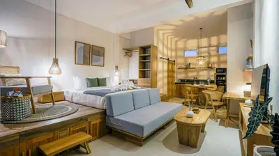 a bedroom with a bed and a living room at Alaya Homes D - Chic Japandi Loft Suite in Seminyak in Seminyak