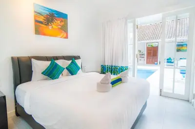 a bedroom with a large white bed in a room at Villa Ley Charming 2 Bedroom Villa Seminyak Private Pool in Seminyak