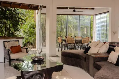 a living room with a couch and a table at Villa Arev in Kerobokan