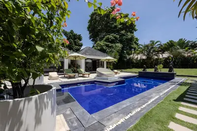 a swimming pool in the backyard of a house at Villa Arev in Kerobokan
