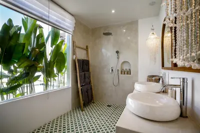 a bathroom with two sinks and a plant at Villa Passion by Alfred in Bali in Seminyak