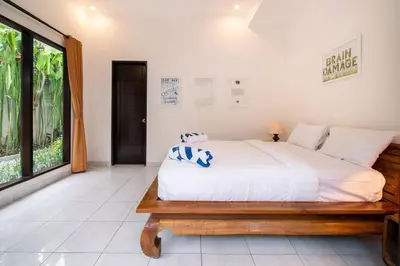 a bedroom with a bed and a large window at Villa Banua 3 Seminyak in Seminyak