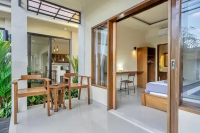 a bedroom and dining room with a bed and a table at Villa Kumaru Luxury 4BR inc breakfast and airport pickup in Canggu