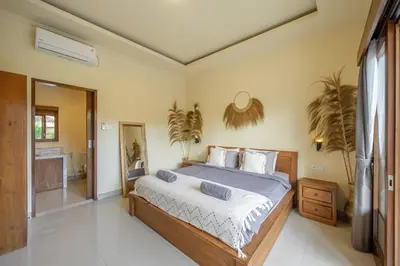 a bedroom with a large bed in a room at Villa Kumaru Luxury 4BR inc breakfast and airport pickup in Canggu