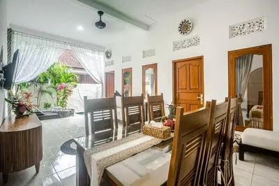 a living room with a table and chairs at Villa Jasmine by JB VIllas in Seminyak