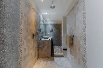 a bathroom with a walk in shower and a sink at Villa Tranquil Holiday Villa in Seminyak