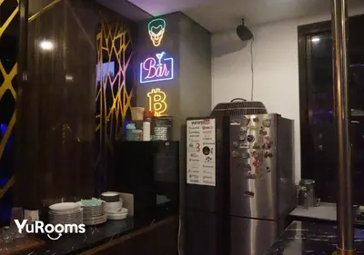 a kitchen with a refrigerator and a neon sign at YuRooms Villapartment - Love Room Bali in Jimbaran