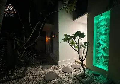 a plant in a room with a green light at YuRooms Villapartment - Love Room Bali in Jimbaran