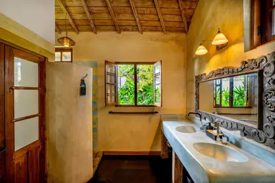 a bathroom with two sinks and a mirror at Villa Amsa by Pertama Management in Seminyak