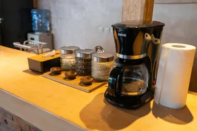 a coffee maker sitting on top of a counter with coins at Villa Amsa by Pertama Management in Seminyak