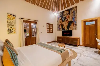 a bedroom with a bed with a camera on the wall at Villa Amsa by Pertama Management in Seminyak