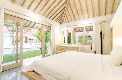 a bedroom with a bed and a large window at Luxurious&Spacious 4Br Villa in Seminyak in Seminyak