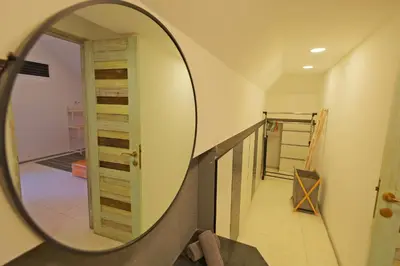 a mirror reflection of a hallway in a house at Beautiful Penthouse w/ incredible views, pool, & cinema room! in Canggu