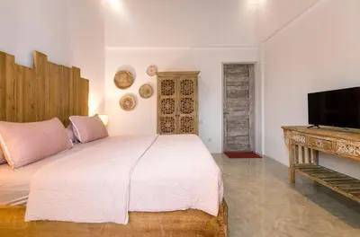 a bedroom with a bed and a flat screen tv at Wonderful 4Br Villa in Seminyak in Seminyak