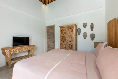 a bedroom with a bed and a tv on a table at Wonderful 4Br Villa in Seminyak in Seminyak